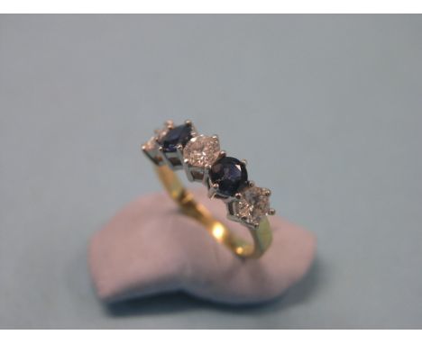 An 18ct. gold half-hoop ring, three diamonds, two sapphires, diamonds approx. 0.6ct.