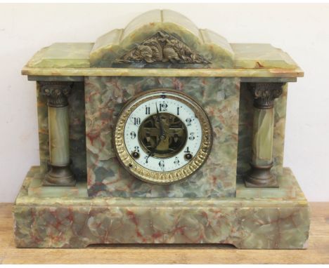 A late Victorian architectural onyx mantle clock with visible escapement, length 40cm. 