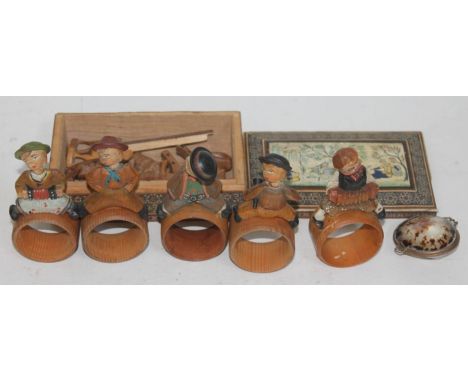 A set of continental carved wooden serviette rings and an Indian Vizagaptam box containing carved wooden animals and a shell 