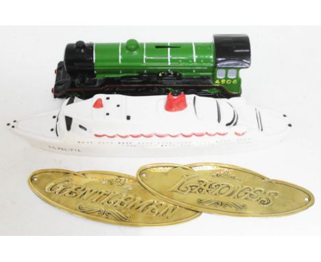 A money box in shape of locomotive, a ceramic ornament in shape of cruiser and two brass door plates "Ladies" and "Gentlemen"