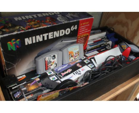 A box containing a boxed Nintendo 64 console, three controllers, various games etc.
