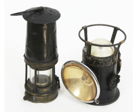A vintage miners lamp and a stadium railway lamp.  