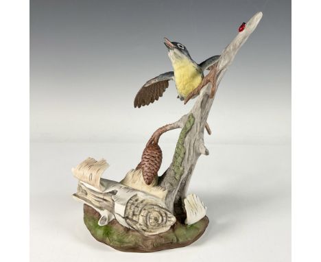 A hand painted bisque porcelain figure of a bird perched on a pine cone branch with a lady bug. Boehm backstamp. Dimensions: 