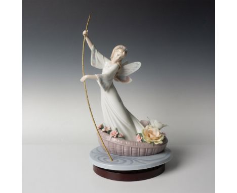 A glossy figural of a fairy elegantly rowing her flower-laden boat across a tranquil lake. Lladro backstamp. Artists signatur