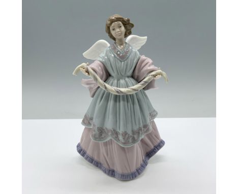 An angel holding out a wreath string in a welcoming pose. Glazed finish. Blue, pink, purple coloration. Lladro backstamp. Thi