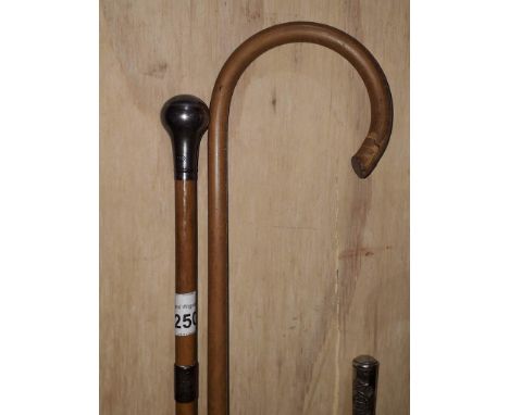 A silver mounted swagger stick and a cane. 