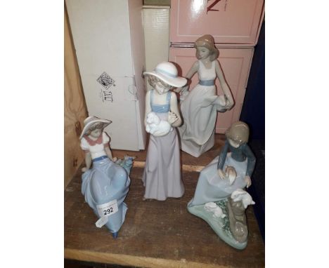 Four Nao figures to include girl dancing, girl sitting and looking at bird, girl holding dog and girl with rabbits, all with 