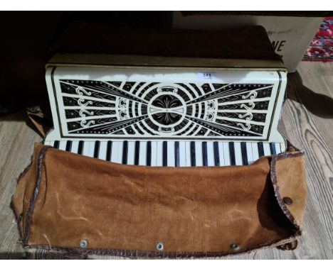 A vintage piano accordion with soft case. 