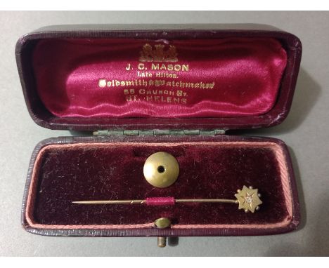 A yellow metal diamond stick pin in associated box. 