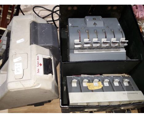 A box Solomatic bus conductor ticket machine and another electronic example. 