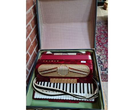 A Hohner Verdi V5 piano accordion with hard case. 