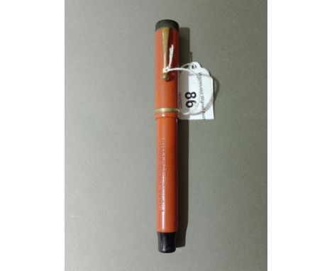 A Parker Duofold "Lucky Curve" fountain pen in orange and black, with 14k gold nib.Condition:-General wear through age and us