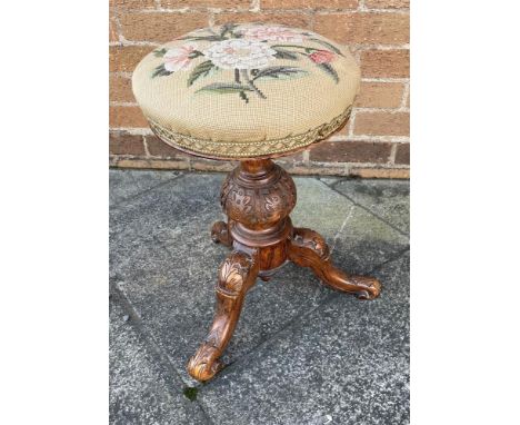 AN EDWARDIAN REVOLVIING PIANO STOOL with tapestry upholstered circular seat on carved tripod base, together with another need