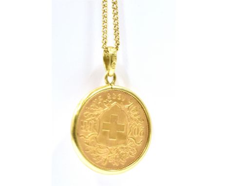 A GOLD SWISS 20 FRANC COIN DATED 1935 Mounted in 9ct gold and suspended on a 9ct gold chain pendant, coin weight 7.9g, chain 