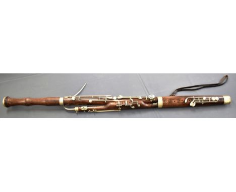 A BASSOON, BY HAWKES &amp; SON  stamped 'EXCELSIOR / CLASS / HAWKES &amp; SON / 28 LEICESTER SQ'RE / LONDON', 130cm long.