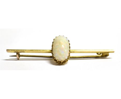 A LATE VICTORIAN 9CT GOLD OPAL BAR BROOCH The pinfire opal measuring 1.4cm by 0.8cm, centrally set on a bar marked 9ct, C cla