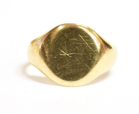 A YELLOW METAL SIGNET RING With vacant bezel, ring size O weight 5.7 g unmarked, testing indicating 18ct