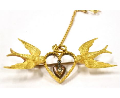 A LATE VICTORIAN 15CT GOLD DIAMOND SET SWALLOW AND HEARTS BROOCH the pin brooch with a swooping swallow at each end in textur