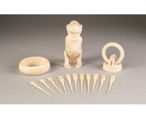 AFRICAN CARVED ONE PIECE IVORY MODEL OF A SEATED MONKEY, 4 ¾" (12cm) high, together with an IVORY BANGLE, and a CARVED SECTIO