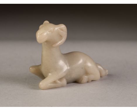 CHINESE CARVED MUTTON FAT JADE COLOURED HARDSTONE MODEL OF A RAM, modelled kneeling, 2 ½" (6.3cm) high