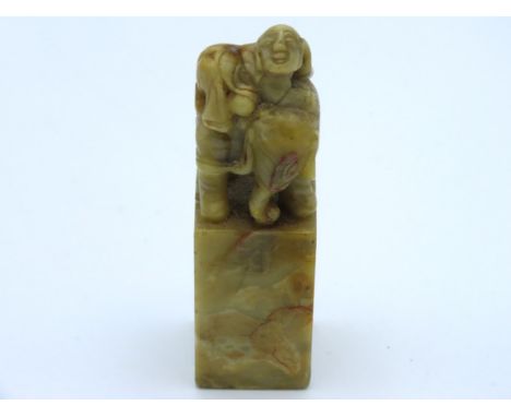 A detailed 19thC. Chinese hardstone seal depicting man & elephant, 75mm tall