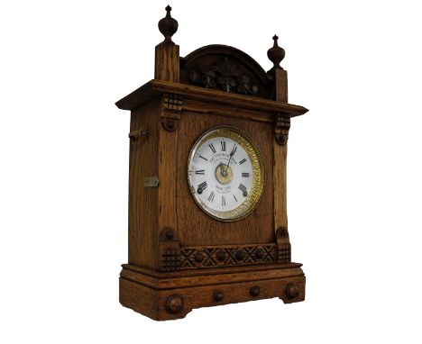An early 20th century oak cased mantel clock by Fattorini &amp; Sons of Bradford