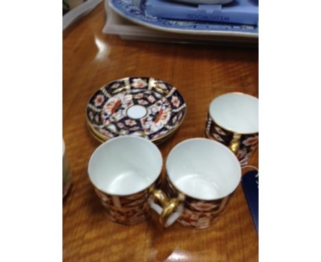 THREE ROYAL CROWN DERBY COFFEE CANS WITH SAUCERS,
along with an 'M Redon' Limoges part coffee set and silver plated butter di