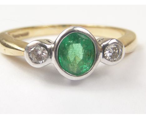 Three stone ring with collet set emerald and two diamonds in 9ct gold. Size "J1/2". Condition Report. Approx .02ct