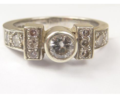 Diamond ring with collet set brilliant flanked by ten others smaller, in 9ct white gold. Size L. Condition Report. Centre sto