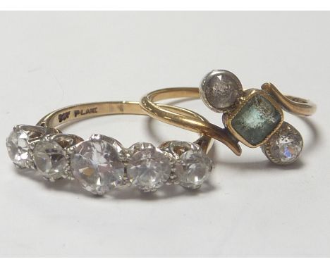 Paste and emerald cross over ring "18ct" and a similar five stone ring in 9ct. (2)