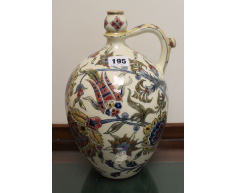 Zsolnay Pecs ewer of ovoid form decorated with flowers in the Persian style in polychrome and gilt, 30cm high. Condition Repo