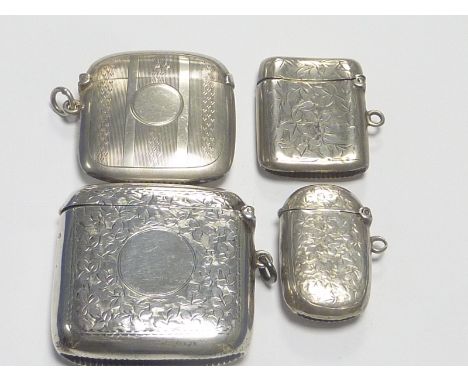 Three engraved silver vesta cases and another, engine turned. (4)