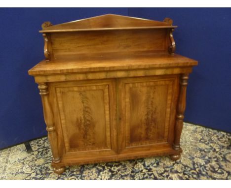 19th century mahogany chiffonier in the manner of Gillows, the shelf back on scroll supports above pair of single panel cupbo