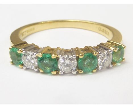 Diamond and emerald seven stone ring in 18ct gold, size "M".