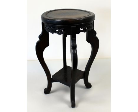 Early 20th century Chinese two tier jardiniere stand with scroll legs and pierced foliate frieze, 49cm high.