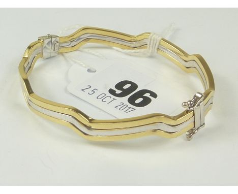 Yellow and white gold waved hinged bangle "750". Condition Report. 15.5g