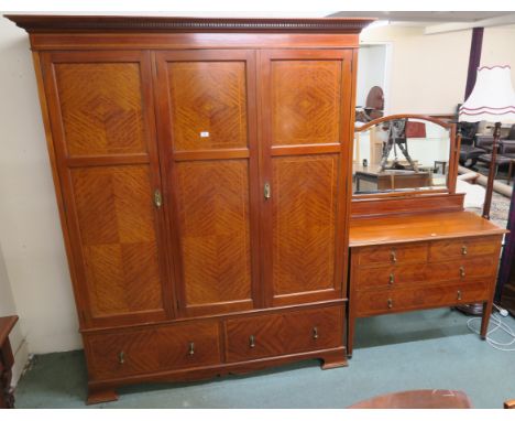 An inlaid mahogany three door fitted wardrobe with two lower drawers on bracket feet, 204cm high x 166cm wide x 57cm deep wit