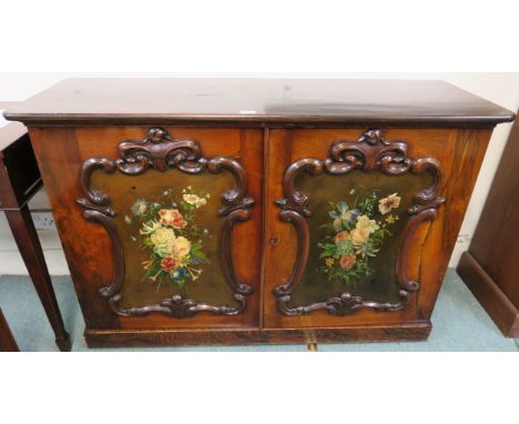 A two door cabinet with floral painted panels within carved frames, 86cm high x 129cm wide x 45cm deep Condition Report: Avai