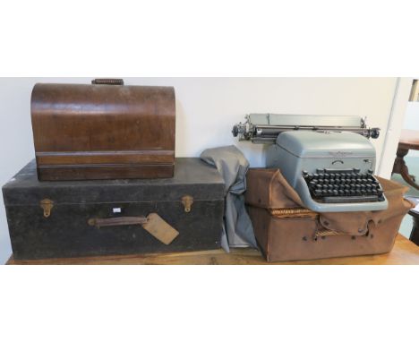 A Singer sewing machine, picnic hamper with cover, Remington typewriter and an Electrolux wooden box (4) Provenance: The Late