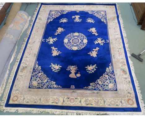 A large blue ground Chinese rug, 366cm x 274cm Condition Report: Good overall condition with some staining on carpet and frin