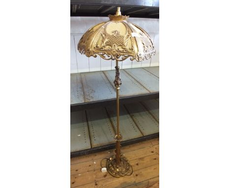 A gilt metal leaf form standard lamp and ornate shade