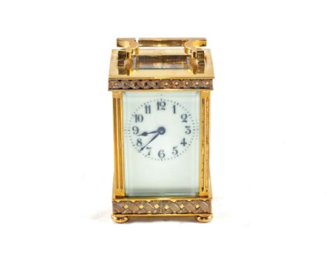 A Brass carriage clock with cream enamel dial