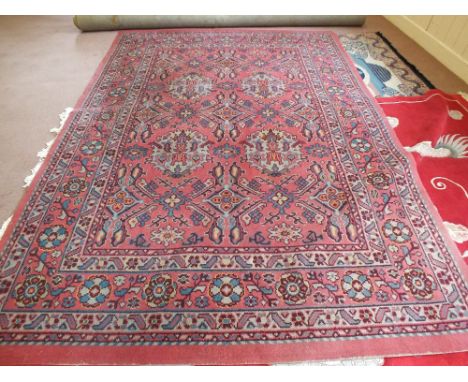 A machine made red floral carpet, 140" x 106"