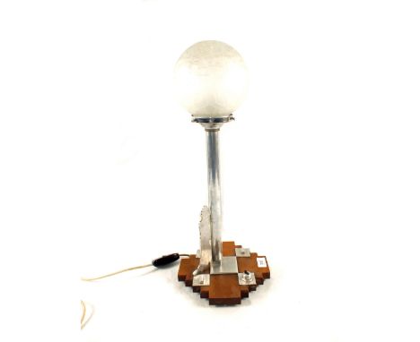 A chrome Art Deco table lamp with frosted glass globe