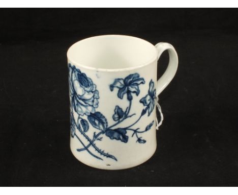 An 18th Century Worcester blue and white mug, rose and lily decoration, crescent mark (hairline base crack)