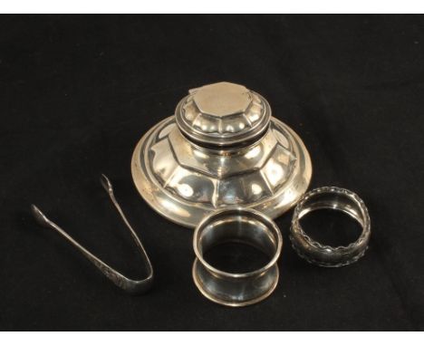 A Silver Capstan inkwell, serviette rings and tongs