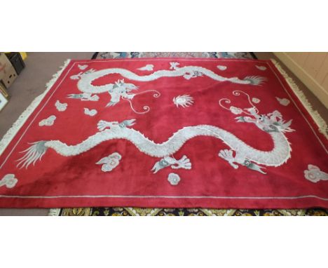 A Chinese red ground carpet with two dragon decoration, 144" x 106"