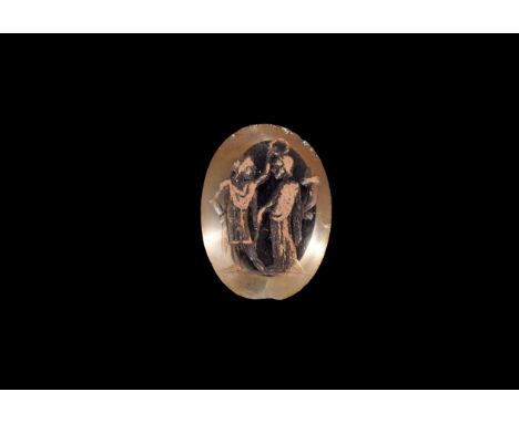 An undated archaistic discoid polished glass plaque with intaglio scene of Abundantia in peplos dress holding a cornucopia, w