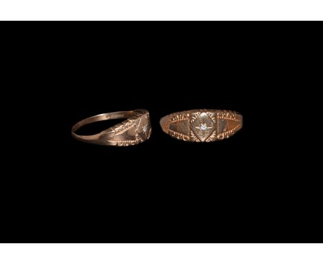 Hallmarked 1980 AD. A flat-section 9 carat gold hoop, expanding shoulders with scrolled edges, raised lozengiform plaque with