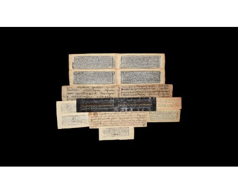 18th-19th century AD. A group of fourteen paper prayer pages with Tibetan text, some hand written in black ink, some print bl